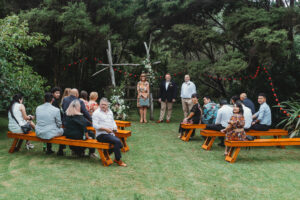 Driftwood Wedding Archway at outdoor wedding Ceremony with bench seating