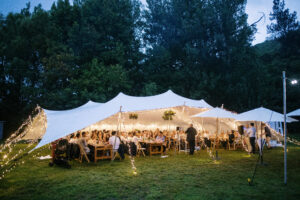 Stretch Tent Wedding Celebration illuminated with lights at night