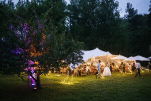 Stretch Tent Wedding Celebration illuminated with lights at night