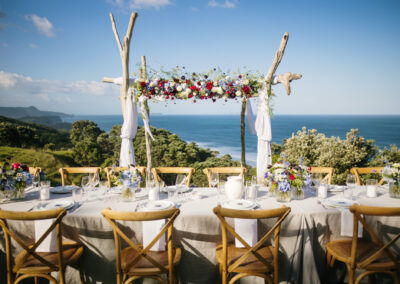 Outdoor open-air wedding with floral driftwood arch